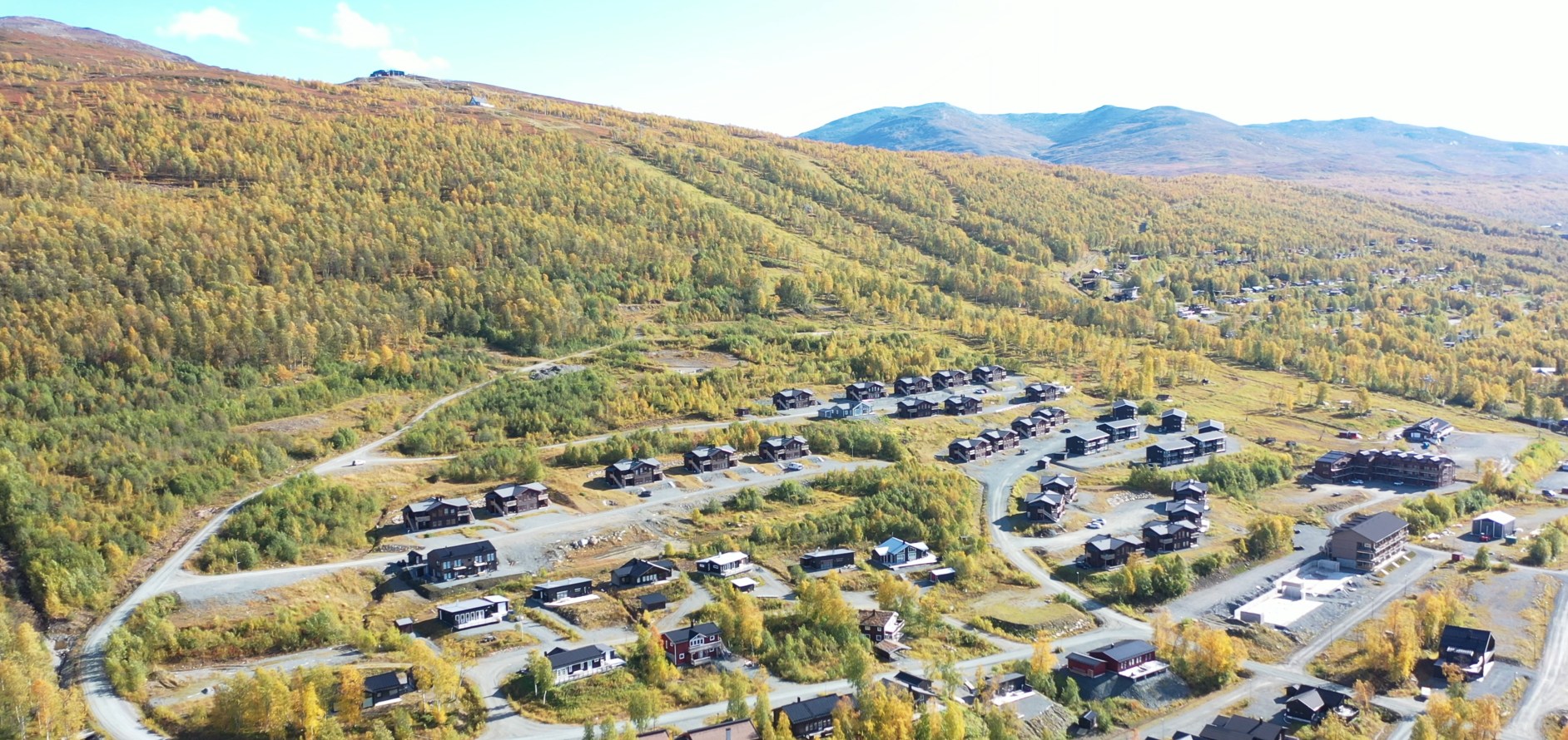 Aerial view of Hemavan with autumn-colored mountains behind